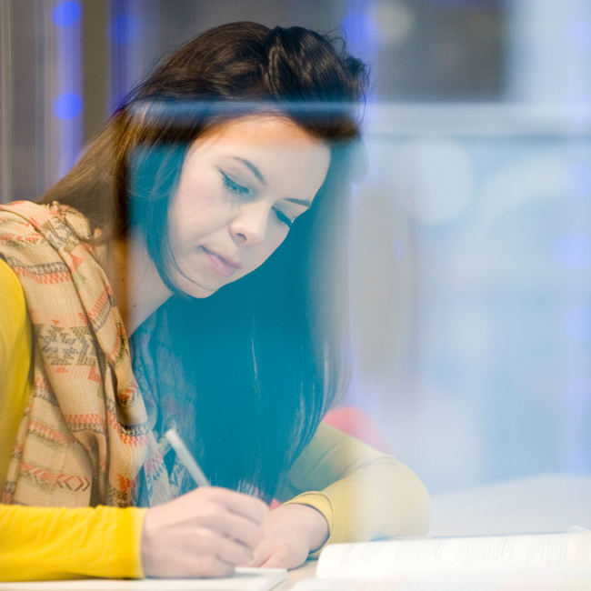 student studying in library