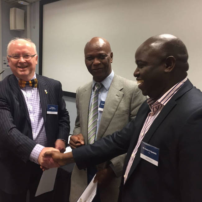 Careed conference prizegiving event showing CAREED Prof. John Struthers (Director), Dr Adebisi Adewole (Deputy Director) and conference participant.