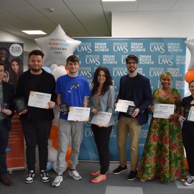 Group photograph of the seven winners from the 2023 Kick Start Business Idea Competition