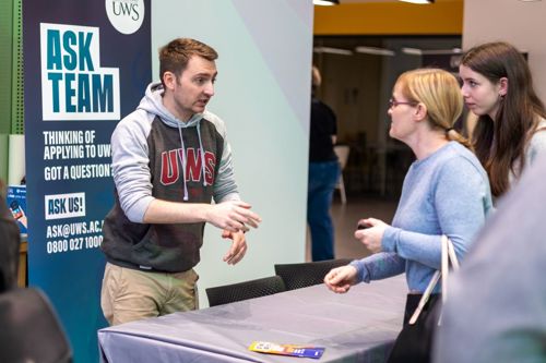 UWS 'Ask Team' member of staff taking to two prospective students at the UWS Lanarkshire Campus Open Day