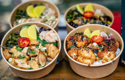 Four dishes containing a mix of vegan and vegetarian street food